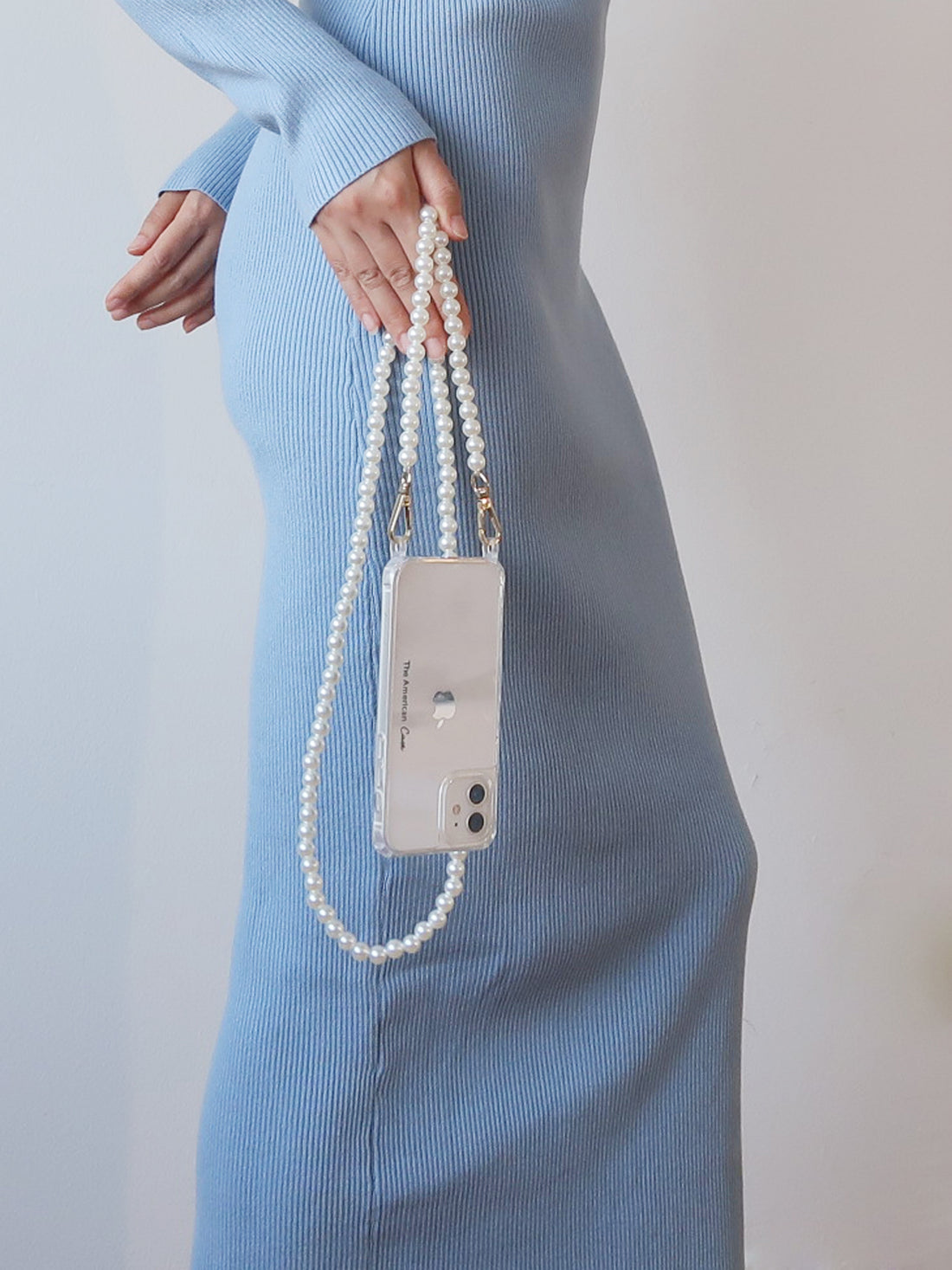 White Pearl Chain with Silver Carabiners attached to phone hold by a lady