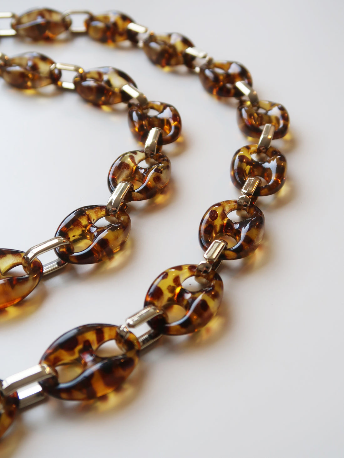 Brown Tortoiseshell Resin and gold tone Metal chain detail