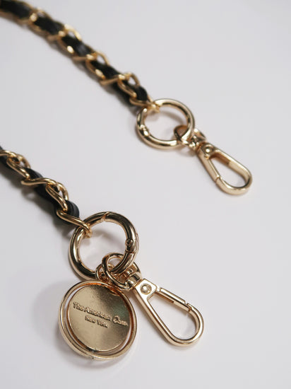 detailed black leather and gold metal bracelet phone chain