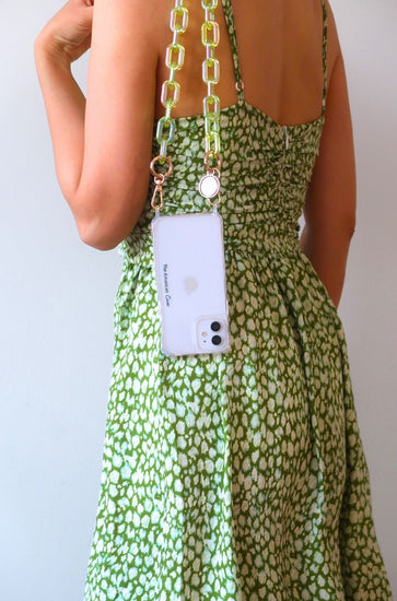 Green Iridescent phone link chain accessory with golden carbineers attached to clear iPhone case