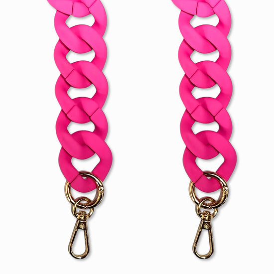 A close-up view of a Fuchsia pink-colored oval link long phone chain made of matte resin with golden carabiners.