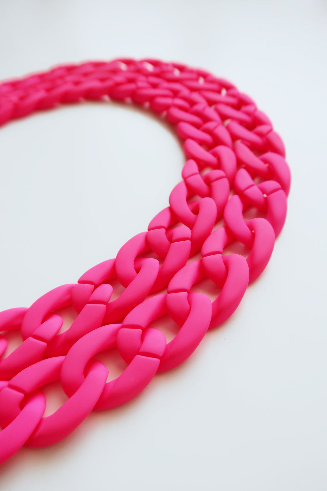 a closer look to the details of a Crossbody neon pink color Matte Resin Phone Chain with Golden Carabiners